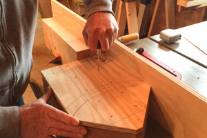 Using the fastener layout location inserts to mark both top and bottom of redwood base for predrilling